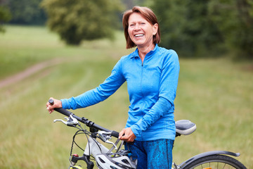 Fototapeta na wymiar Active senior woman is doing a bike ride