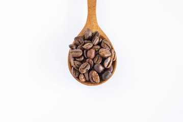 Roasted coffee beans on wooden spoon