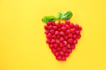 Composition with ripe raspberry on color background