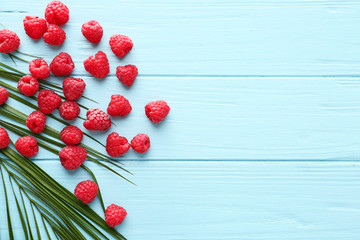 Many ripe raspberry on wooden background