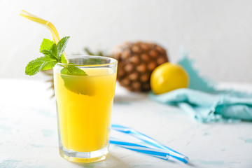 Glass of fresh pineapple juice on light table