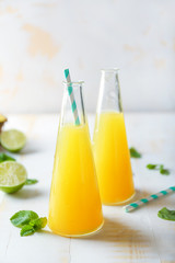 Bottles of fresh pineapple juice on light table