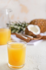 Glass of fresh pineapple juice on light table