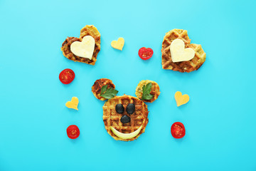 Composition with mouse face and hearts made of squash waffles on color background