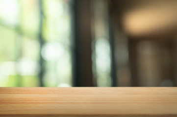 Empty wooden tabletop with blur montage restaurant background.