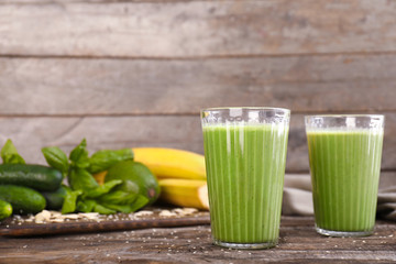 Glasses of healthy smoothie on wooden table
