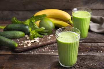 Glasses of healthy smoothie on wooden table