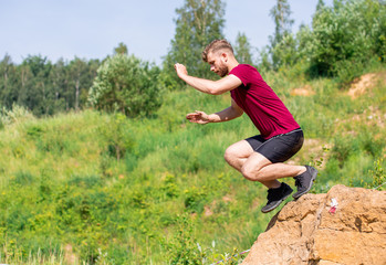 Fototapeta premium Runner overcome rocks obstacles in the cross-country race