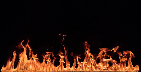 Texture of fire wall isolated on a black background.