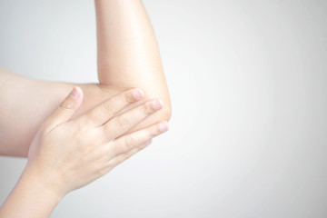 A woman using a hand rub creams