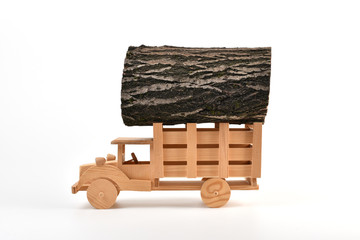 Wooden toy truck with a load of logs. Lumber delivery concept.