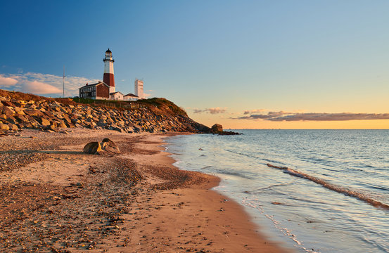 Montauk Lighthouse and beach at sunrise, Long Island, New York, USA.