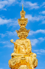 Fototapeta na wymiar Ten-way Puxian gold statue at the top of Emei Mountain in Sichuan Province, China