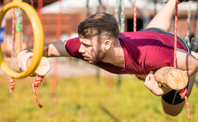 Hanging rings obstacle overcome by runner at the extreme race