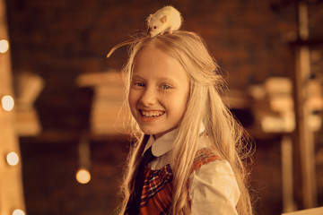 smiling preteen girl with rat on the head