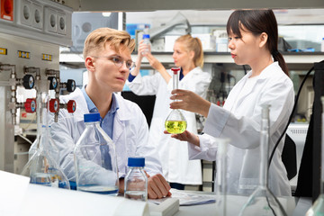 Portrait of group of European and Chinese scientists working together at biochemical laboratory