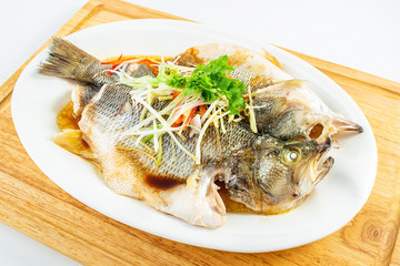 Chinese Cantonese cuisine dish with steamed squid on white background