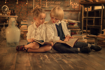 schoolchildren reading books while sitting on the floor