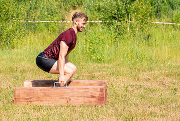 Farmer walk during obstacle race training in the boot camp