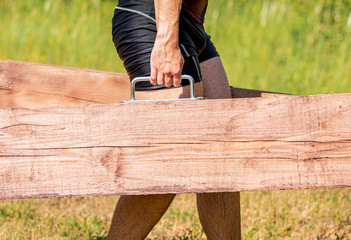 Farmer walk during obstacle race training in the boot camp