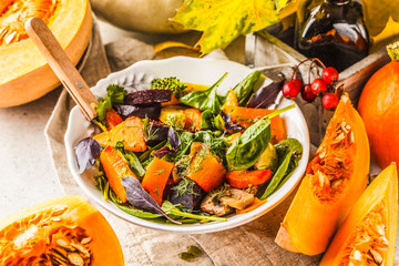 Autumn salad with baked pumpkin, beet, zucchini and carrots. Healthy vegan food concept.