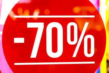 Sale sign 70 percent in a fashion clothes shop display window