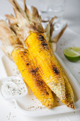 Baked corn with spices and yoghurt sauce