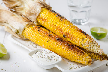 Baked corn with spices and yoghurt sauce