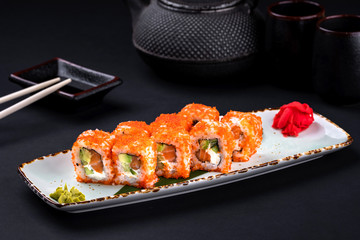 Close up of sashimi sushi set with raw salmon, avocado and cheese philadelphia and soy with...