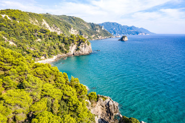 Aerial view of beautiful seashore in summer. Rocky beach and green islands seen from above.