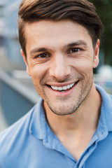 Fototapeta premium Handsome young man dressed casually spending time outdoors