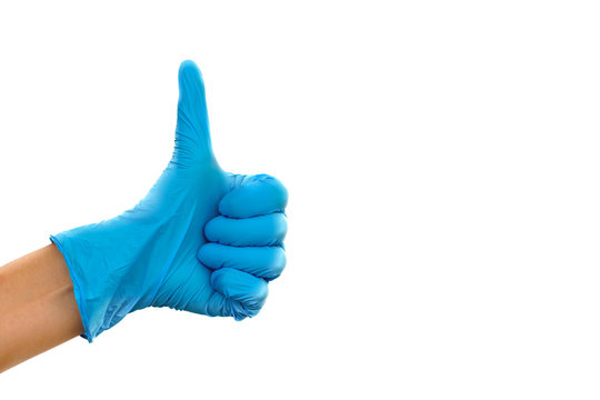 Hand with blue medical glove showing symbolic gestures. Close up of human hand in blue rubber medical glove showing ok sign with thumb up.