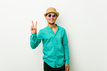 Young hispanic man wearing a summer clothes showing number two with fingers.