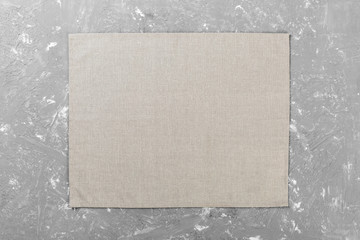 gray cloth napkin on brown rustic wooden background top view with copy space