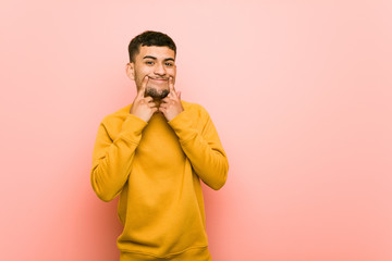 Young hispanic man doubting between two options.