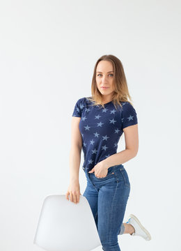 Portrait of a beautiful caucasian young woman posing against white wall background. The concept of a beautiful well-groomed woman.