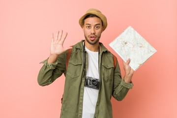 young filipino traveler holding a map