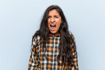 Young cool indian woman screaming very angry and aggressive.
