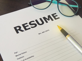 Job Application Form Have pens and glasses. Closeup of Resume.