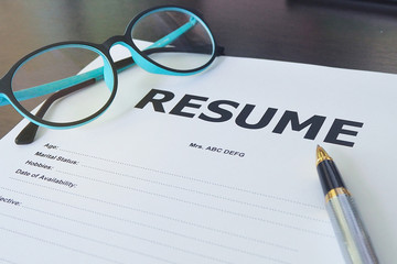 Job application form have pens and glasses. Close up of Resume