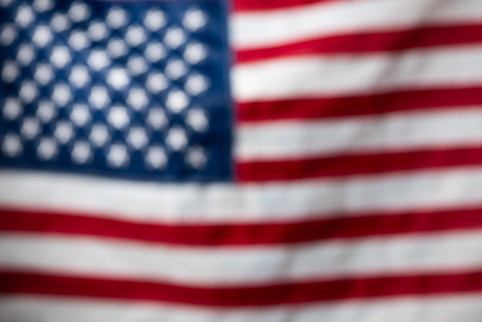USA American United States flag defocused blurred bokeh backdrop.
