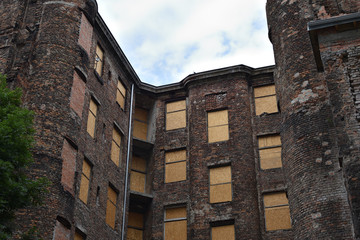 Old red brick house in a former Jewish ghetto from World War II at Kamienico, Walicow street, Warsaw city, Poland