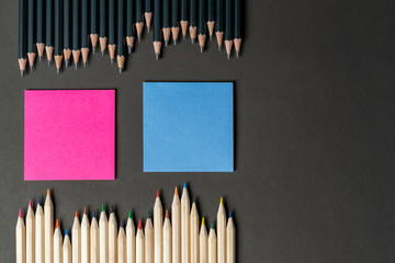 pencils in white and black with pink and blue notes. Mock up, copy space. Office or business planning topic, creativity, ideas, variability by different genders. Female and male.