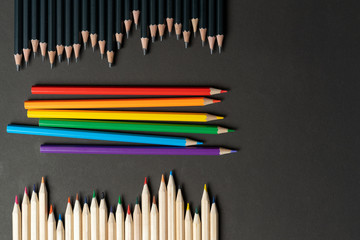 set black, white and lgbt colored pencils on black paper background. Mock up, copy space. concept tolerance entire population planet living next door. Lgbt selection