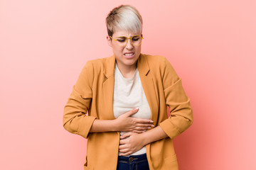 Young caucasian woman wearing a casual business clothes sick, suffering from stomachache, painful...