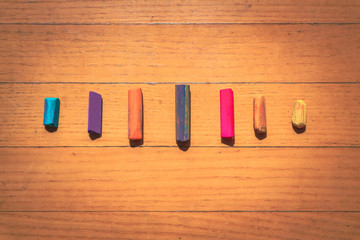 Pastel crayons on wooden background