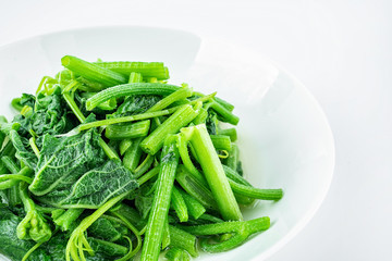 Chinese dish of fried pumpkin vine on white background