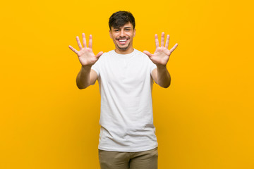 Young hispanic casual man showing number ten with hands.