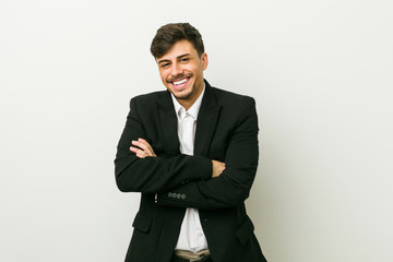 Young business hispanic man who feels confident, crossing arms with determination.