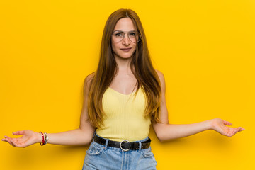 Young redhead ginger woman with freckless showing a welcome expression.